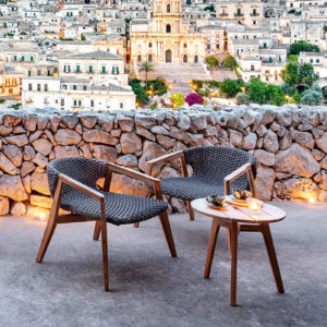 knit-lounge-chair-ethimo-core-furniture-product-2 Ethimo's Knit collection lounge armchairs with a side table outside.