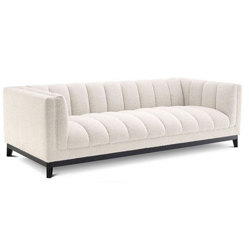 Designer luxurious Sofa Ditmar by Eichholtz available in boucle cream, cambon black and mademoiselle beige upholstery finishes with a black base. Feature deep channel stitching