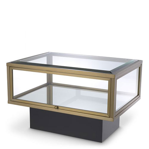 Designer Side Table Ryan by Eichholtz in brushed brass finish with clear glass and mirror glass. Features side glass door and Black base with an integrated shelf of mirror glass