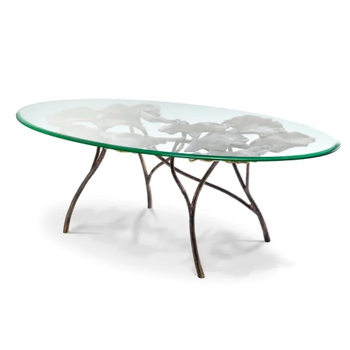 Designer Coffee Table Poseidon by Eichholtz oval in vintage brass with a clear glass table top with leafy decorative detail